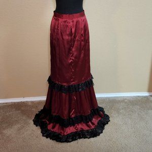 Red bustle pencil skirt with black lace trim.